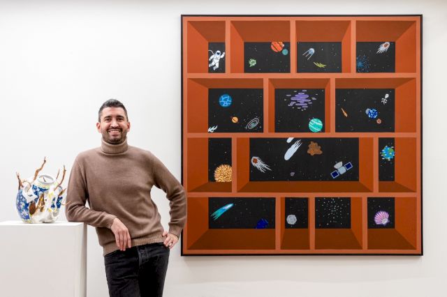 Matteo Novarese infront of Camilla Alberti, ‘Unbinding Creatures, Organism 26’ 2021, Jimmy Milani ‘Untitled (my bookshelf)’ 2022. Photographer Guido Calamosca, Courtesy SOF:ART.